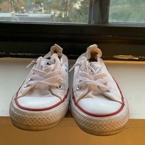 Well-worn white Converse All-Star sneakers